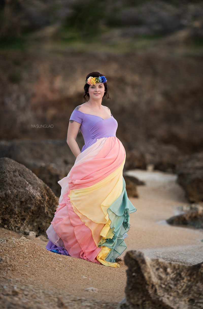 Pregnant mother wearing the Hope Gown in Pastel Tones by Sew Trendy Accessories on a beach.