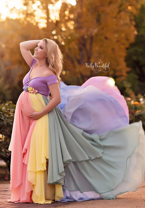 Pregnant mother wearing the Hope Gown in Pastel Tones by Sew Trendy Accessories with trees and sun in the background.