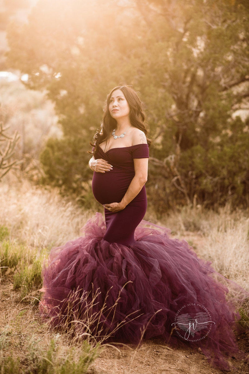 Pregnant mother in the Jacqueline Gown in Plum by Sew Trendy Accessories in a field with trees.