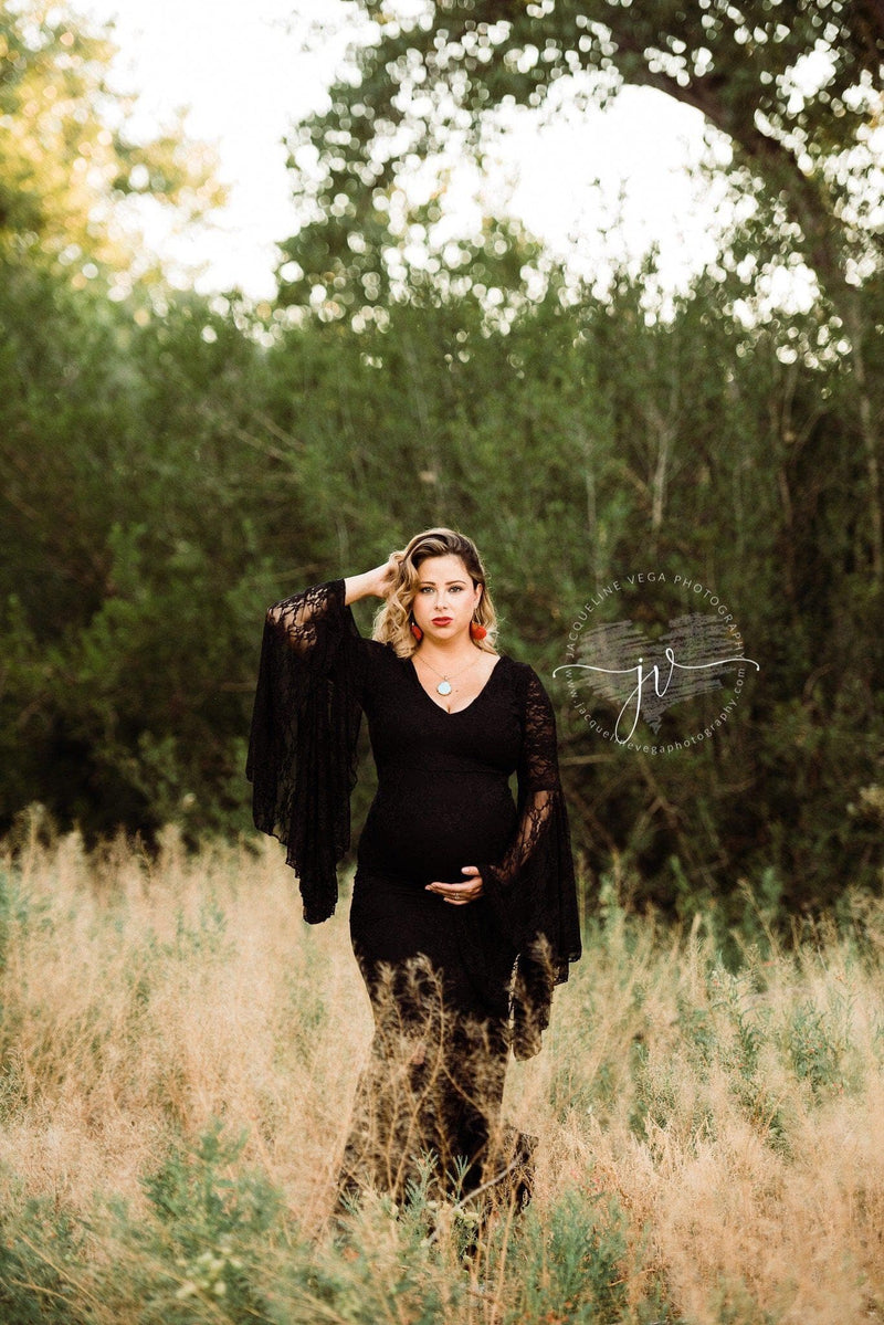Pregnant mother in the Kenra Gown by Sew Trendy Accessories in black with tall grass.