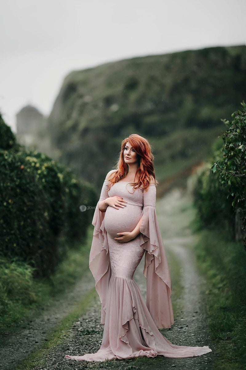 Expecting mother wearing the angora gown in mauve by Sew Trendy standing in field in Ireland.