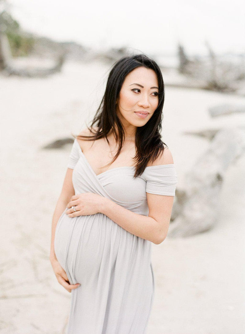 Pregnant Mother in the Kiara gown by Sew Trendy Accessories in grey at the beach.