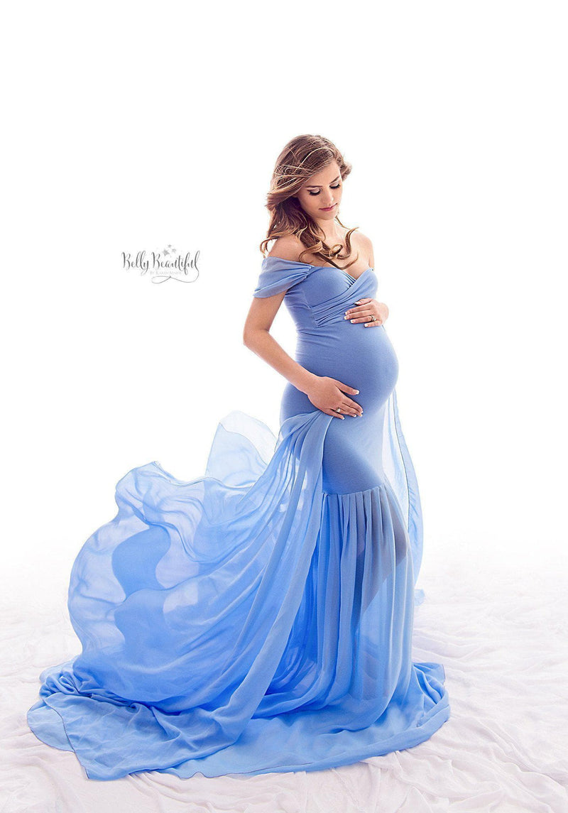 Expecting mother wearing the Angela gown in Periwinkle by Sew Trendy, on a white backdrop.