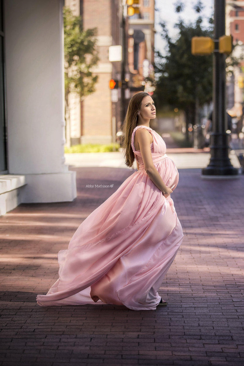 Beautiful pregnant woman wearing the Alma satin skirt for coverage under her Sew Trendy Gown standing on the streets of Central Park.