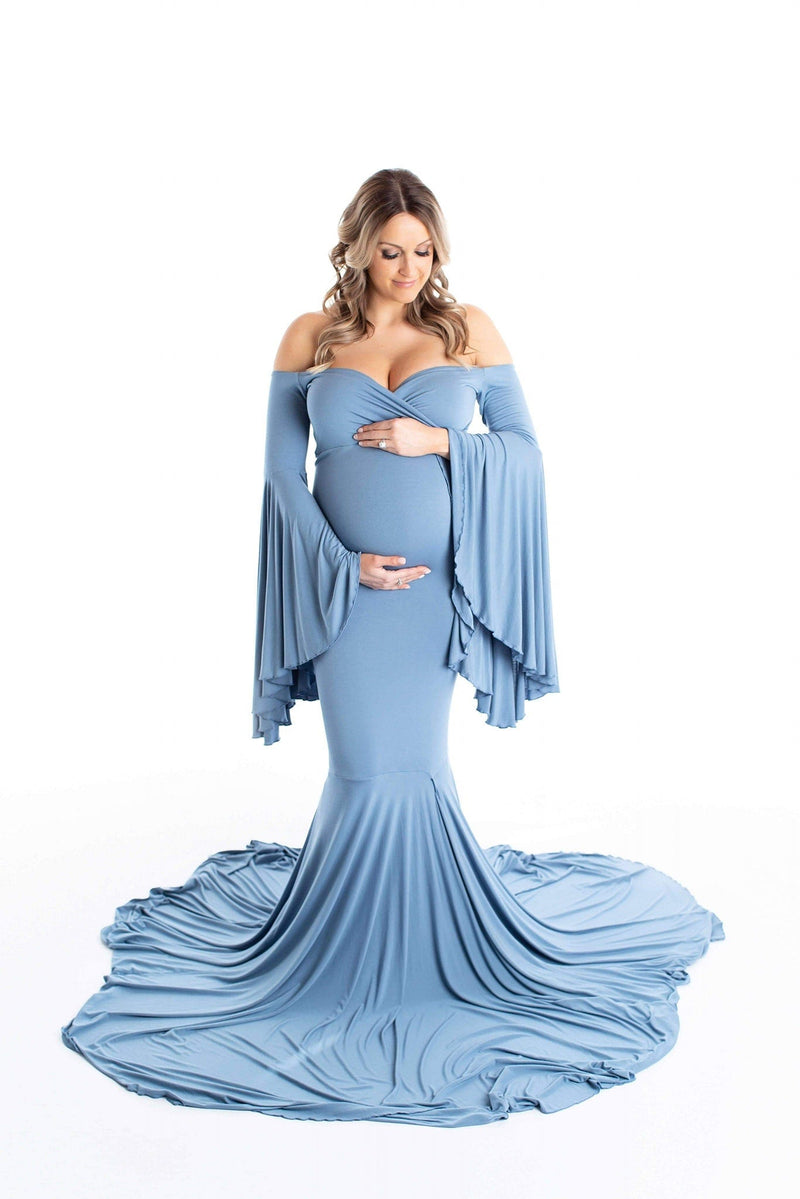 Stunning blonde pregnant woman in a steel blue Sew Trendy Maternity Gown with Bell Sleeves