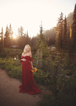 Expecting mother wearing the aspen gown in brick by Sew Trendy standing in Forrest near Mt. Rainier.