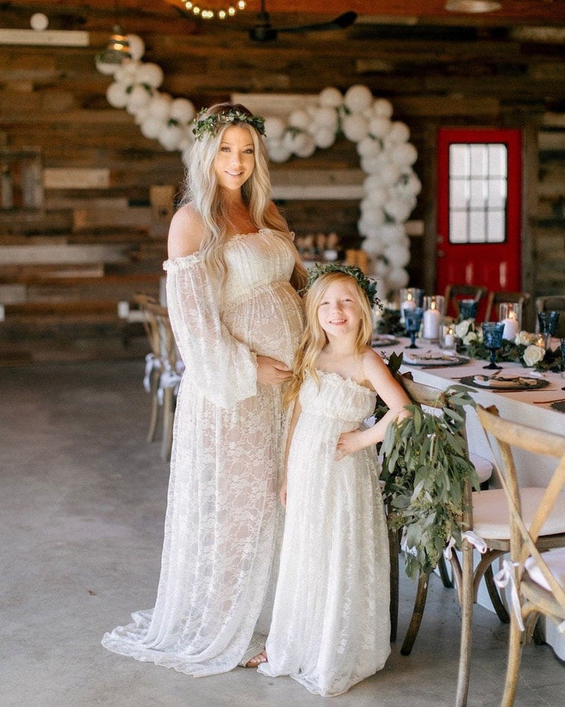 Expecting mother wearing the Valerie gown in ivory by Sew Trendy standing with her daughter in our katie gown
