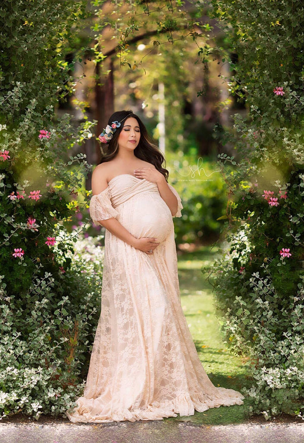 Beautiful pregnant woman wearing the adelia skirt for coverage under another Sew Trendy gown, standing in a garden.