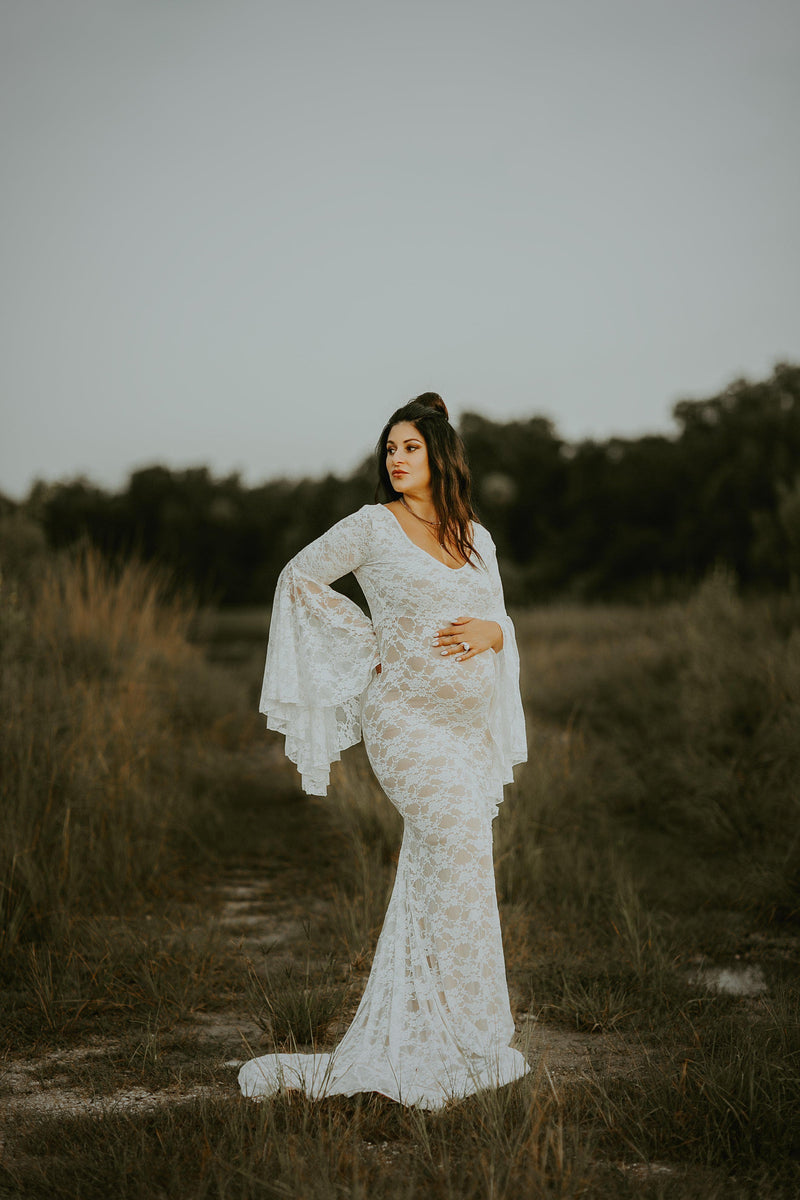 Pregnant mother in the Kenra Gown by Sew Trendy Accessories in Ivory in a field.