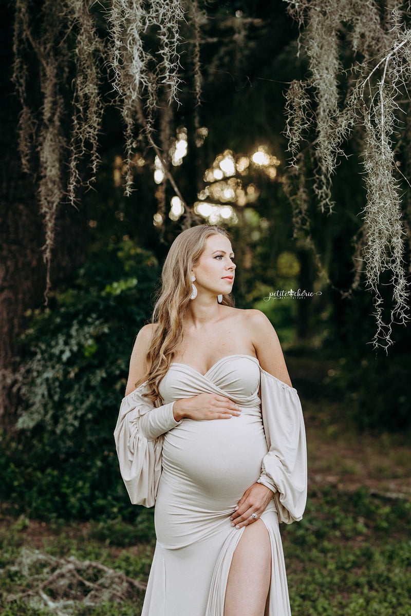 Beautiful expecting mother wearing the Erica gown in champagne by Sew Trendy Accessories, standing in a grove of trees