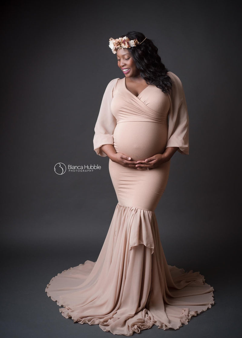 Pregnant african american mother wearing the Francis gown in camel by Sew Trendy standing on grey backdrop in studio
