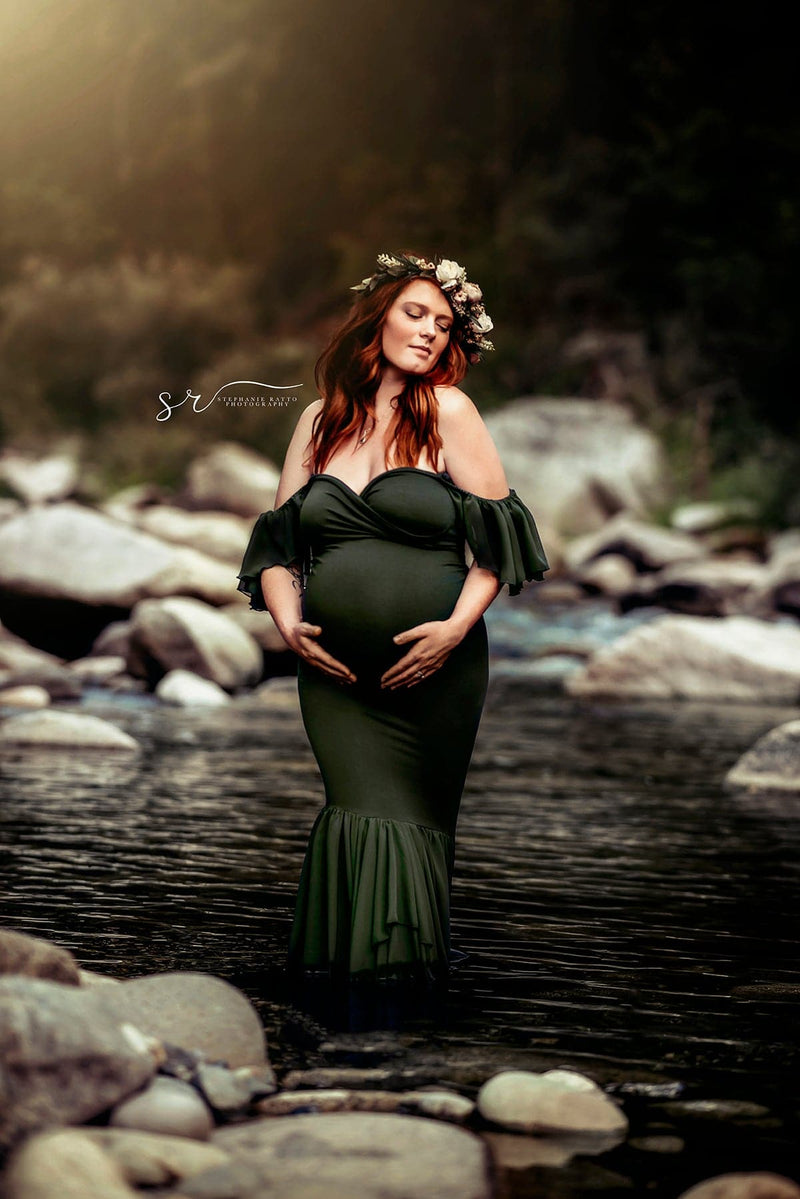 Pregnant woman wearing the Sable in evergreen by Sew Trendy, standing in a river with a flower crown