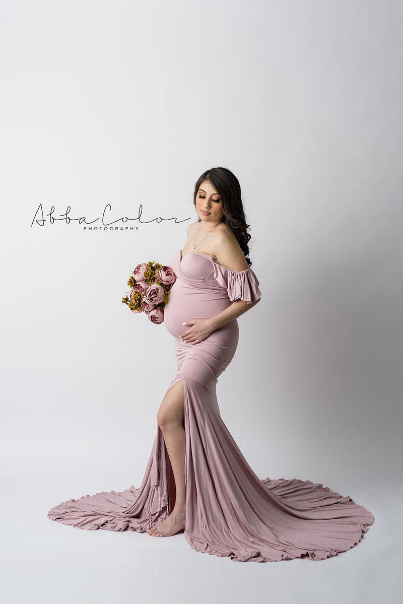 Expecting mother wearing the Serenity in mauve by Sew Trendy standing on white backdrop in studio
