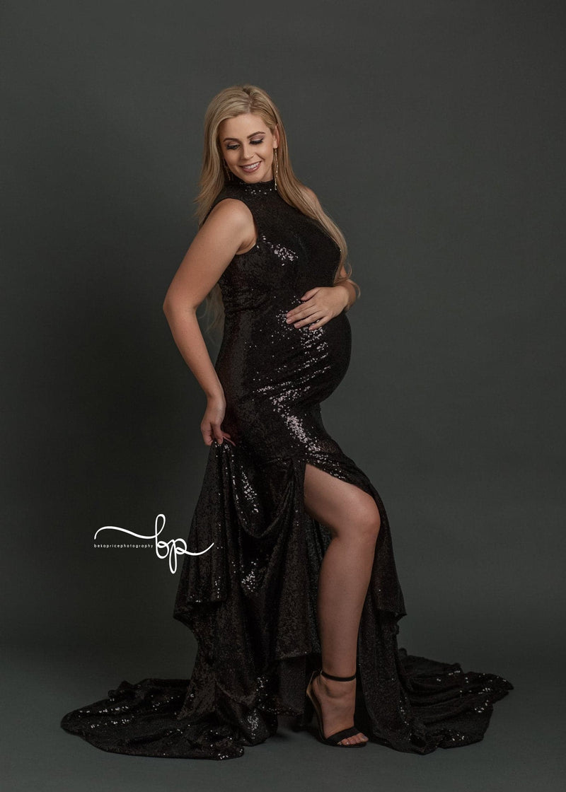 Pregnant woman wearing the allesandra gown in black sequins by Sew Trendy standing on grey backdrop