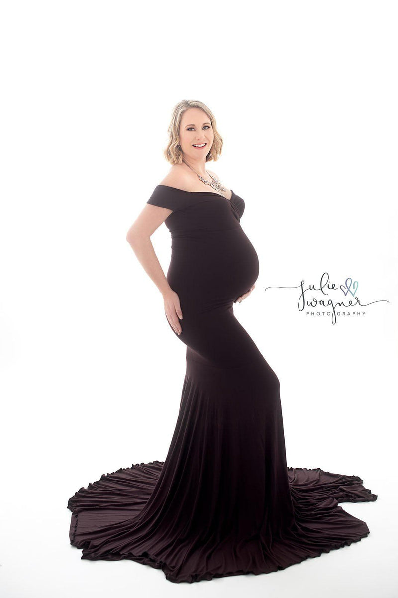 Glowing expecting mother wearing the allysa gown by Sew Trendy in Truffle on a white backdrop.