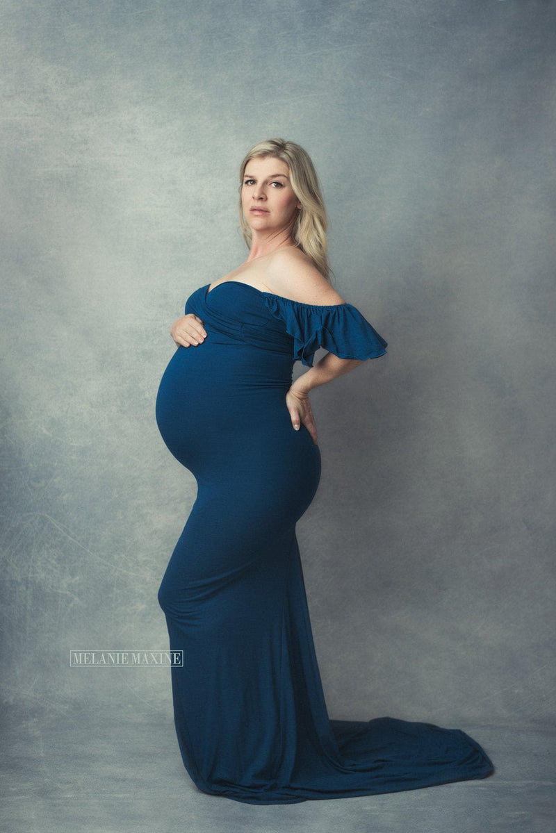 Expecting mother wearing the Arianna gown in Teal by Sew Trendy in studio.