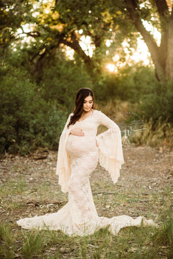 Pregnant mother in the Kenra Gown by Sew Trendy Accessories in champagne with trees.