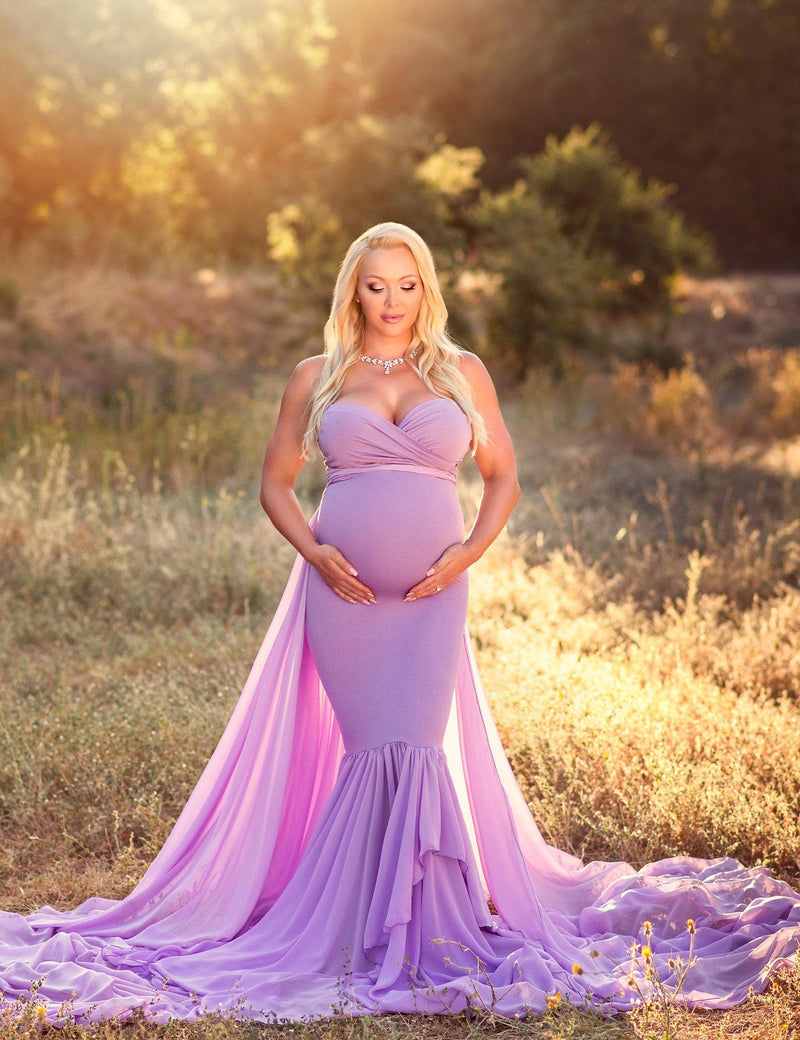 Pregnant mother in the Liv Gown by Sew Trendy Accessories in Lilac outside with trees.