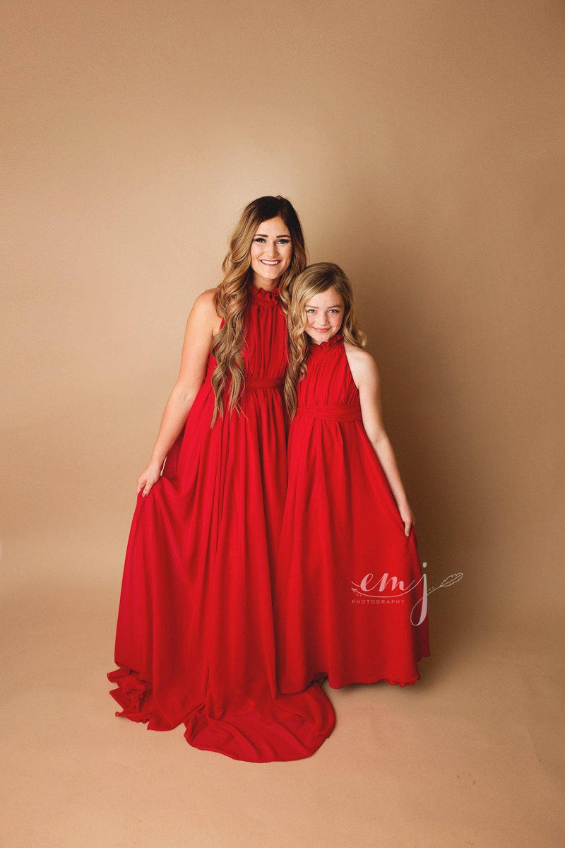 Pregnant woman wearing the Carolynne gown in red by Sew Trendy standing next to daughter in studio