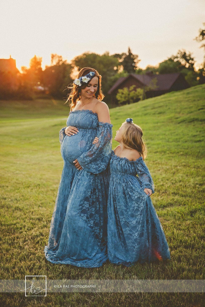 Expecting mother wearing the Valerie in steel blue by Sew Trendy with her daughter wearing a matching gown