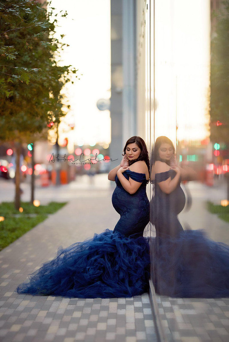 Pregnant woman wearing Celine gown in navy by Sew Trendy standing near building in New York