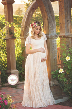 Pregnant mother in the Josephine Gown by Sew Trendy Accessories in Champagne in a garden.
