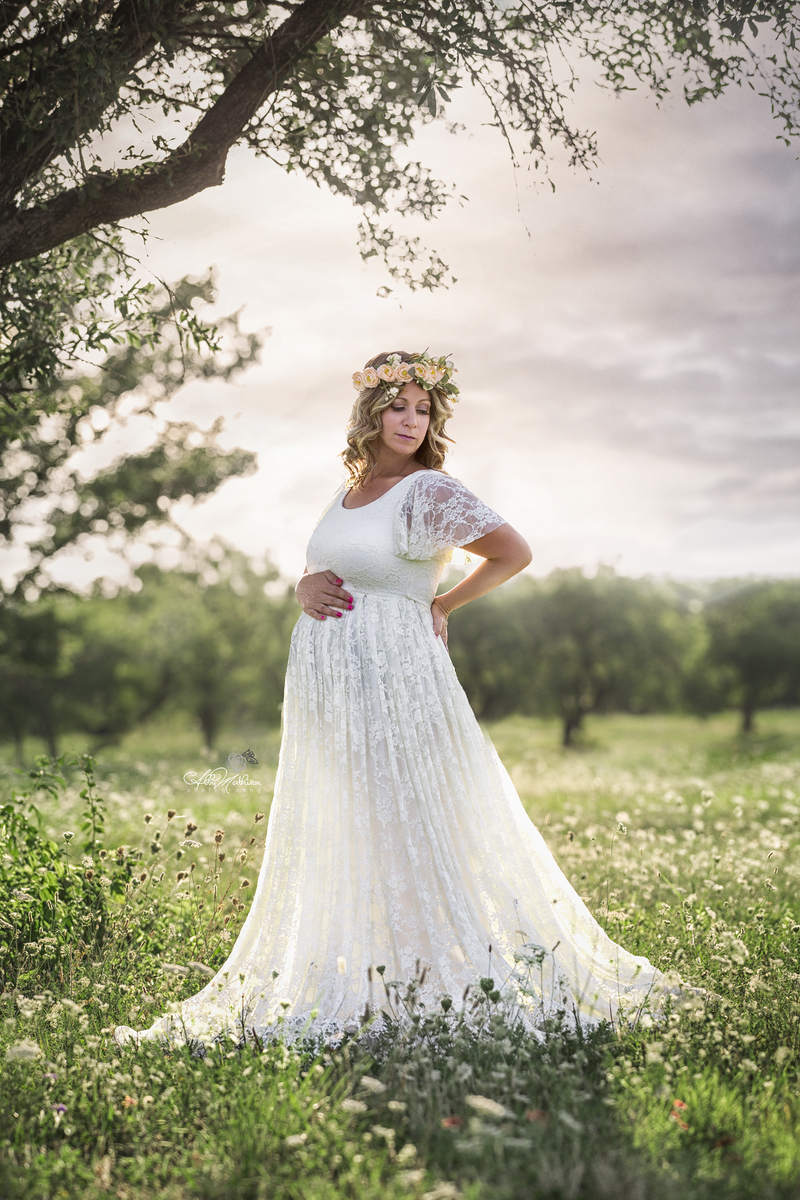 Pregnant mother in the Josephine Gown by Sew Trendy Accessories in White with a flower crown.