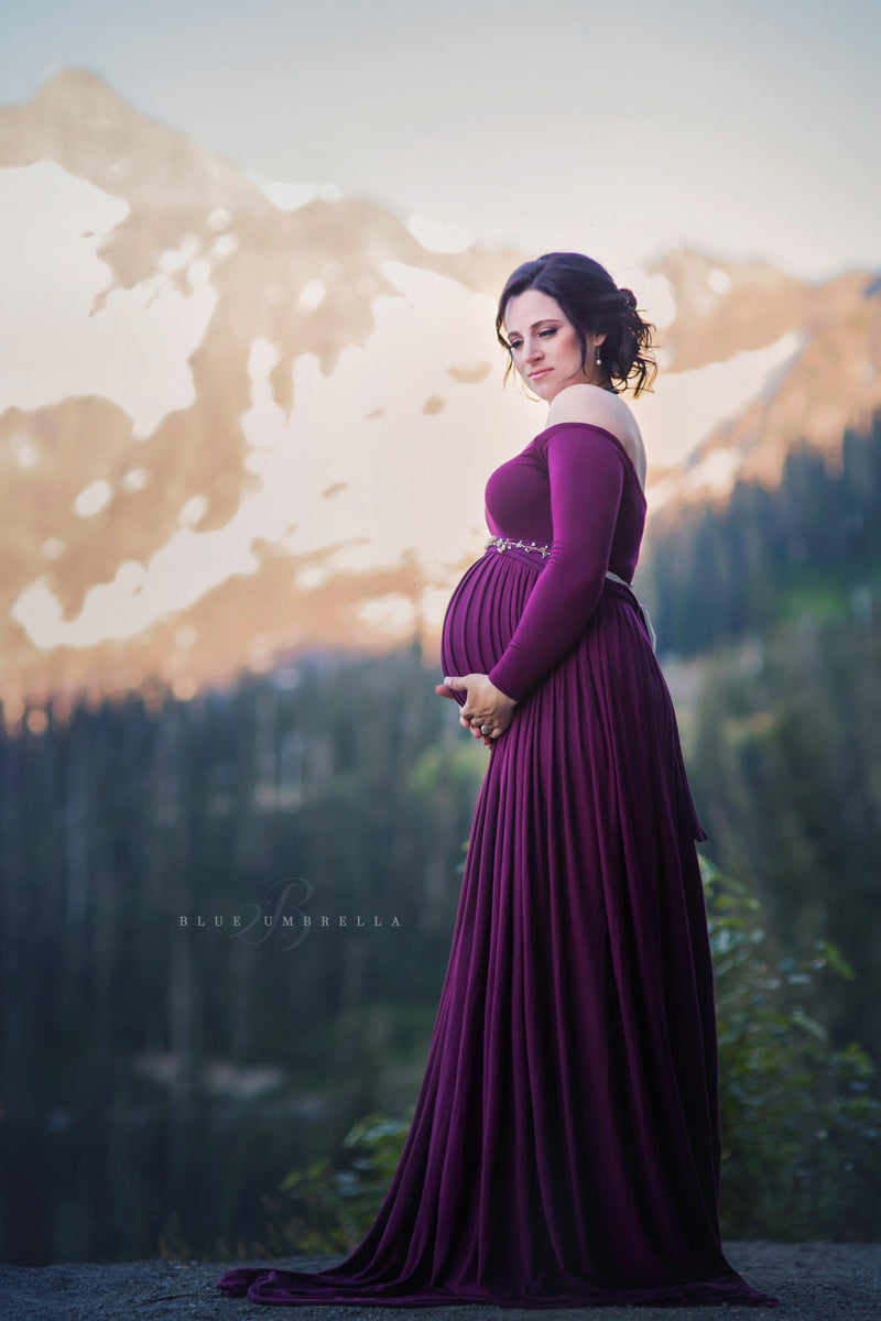 Pregnant woman in the Miriam Gown in Plum by Sew Trendy Accessories with a mountain in the background.