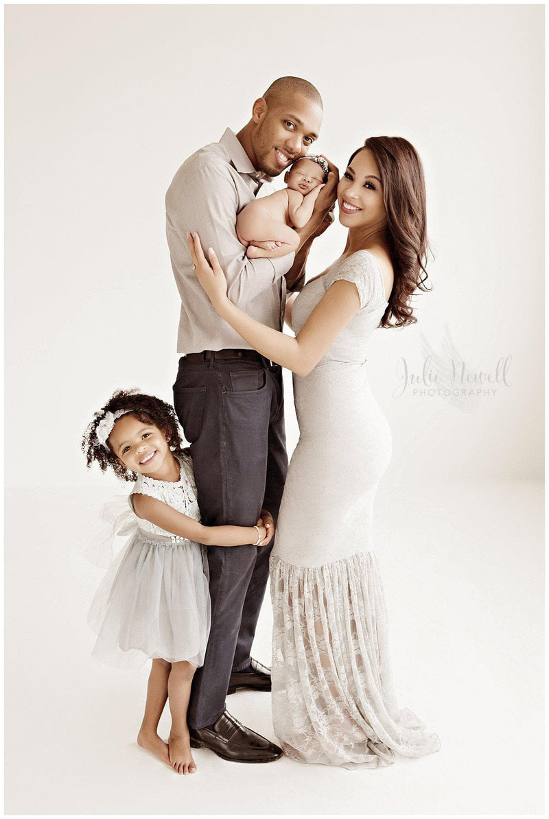 Beautiful woman wearing the bella gown in grey by Sew Trendy standing in studio with her husband and daughter.
